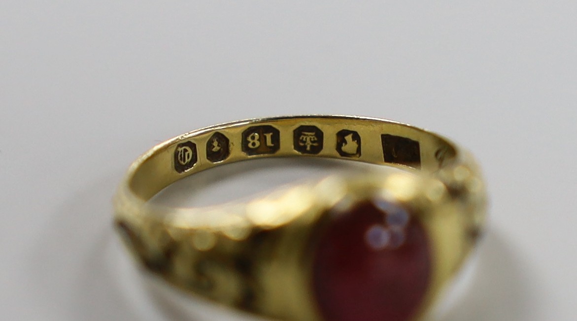 A Victorian 18ct gold, cabochon garnet and black enamel set memorial ring, the shank interior inscribed 'J W Scott obt. 26th Jan, 1851 at 41', size J, gross weight 2.8 grams.